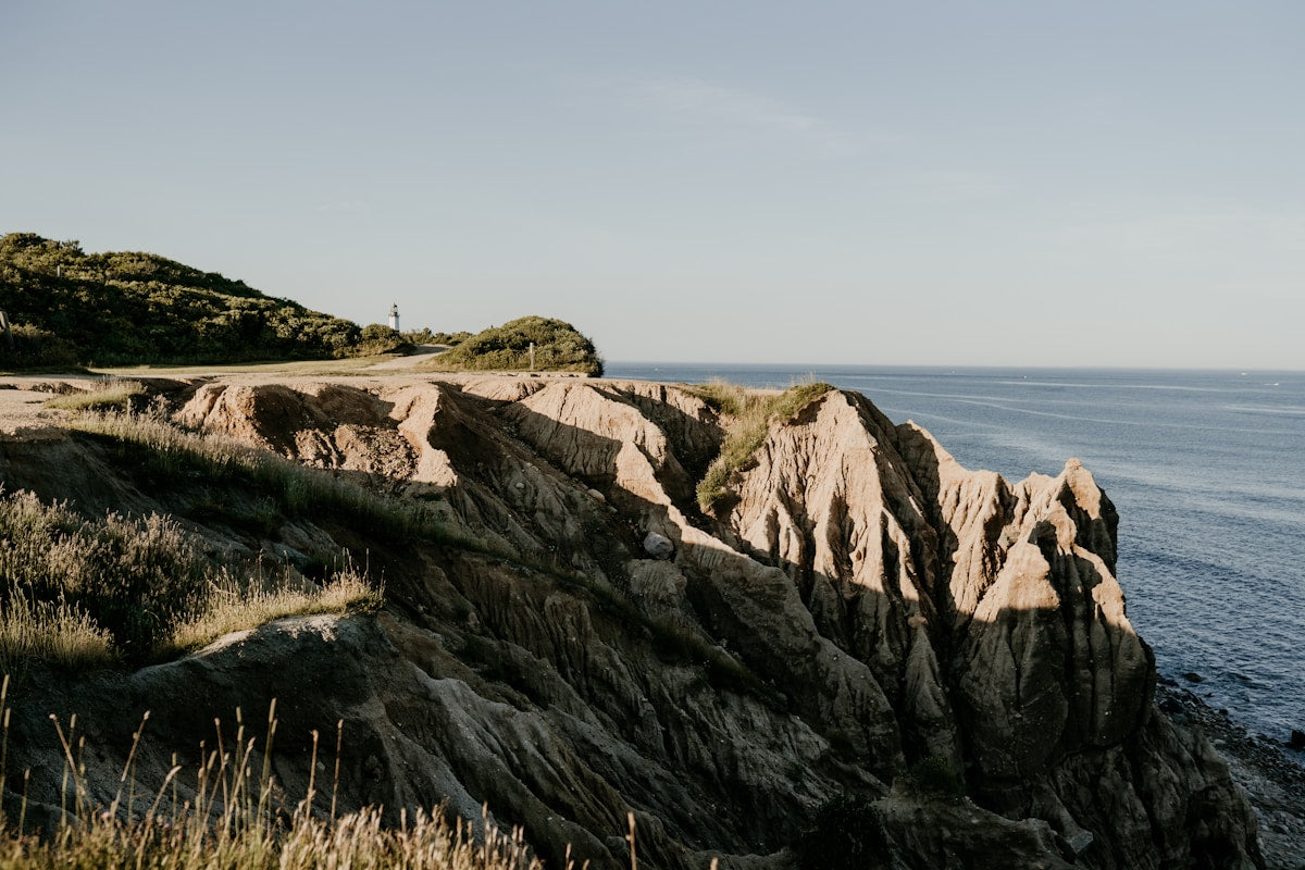 Lighthouse on a rocky coastal headland by the ocean